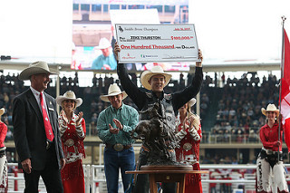 Big Valley native Zeke Thurston holds up his third consecutive cheque of $100,000 from the Calgary Stampede