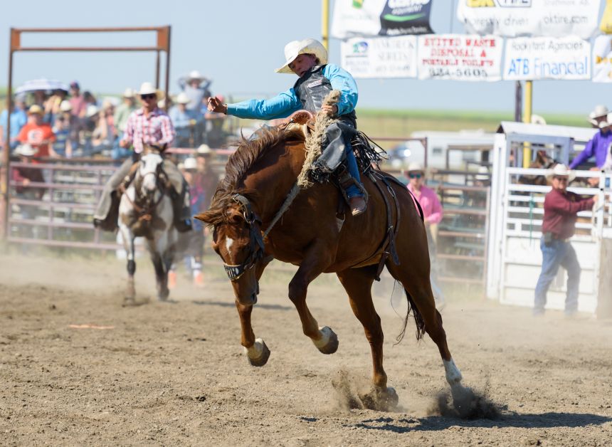 Chance Bohmer of Hillcrest, AB., left, rides Ned Pepper (91) in the Saddle Bronc portion of the 60th annual Rockyford Rodeo.