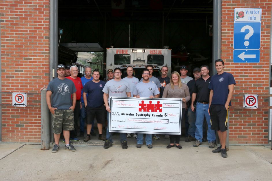The Drumheller Fire Department was able to collect $4,580 at this year’s Canada Day parade for Muscular Dystrophy Canada. Last week the department presented the funds to Amanda Race of Muscular Dystrophy Canada. mailphoto by Patrick Kolafa