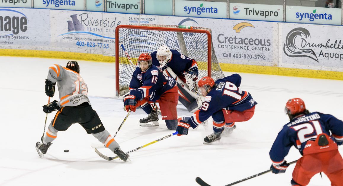 Drumheller Dragons Forward Brady Risk charges the net on Sunday, March 25, during Game 6 of the second series of playoffs against the Brooks Bandits at the Drumheller Memorial Arena. Bandits players Jacob LaPointe, 15, Jack Theis, 19, David D’Agostino, 21, and Goalie Mitchel Benson, 1, attempt to counter the offense. Mailphoto by Terri Huxley