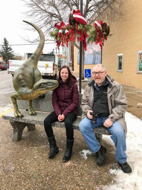 Marley Henneigh and Mike Todor sit on the new bench made possible by the DinoArts Association and the Town of Drumheller. Mailphoto by Terri Huxley