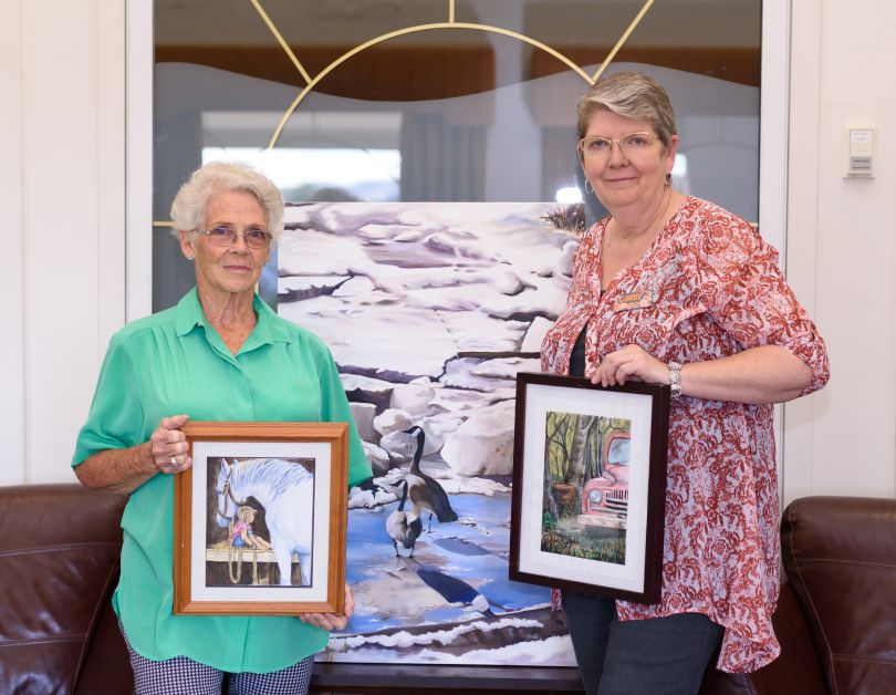  Pat Nelson, left, and Cindy Clarke hold up a few of their original works of art on Monday,August 28. Clarke received a first place win in the advanced category of the Alberta Wide Show as part of the Alberta Community Arts Club Association. Nelson placed first in the beginners category and the two will have their work showcased on the national level.  mailphoto by Terri Huxley