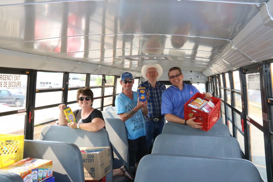 Stuff the Bus organizer Shannon Wade with volunteers Michael Sweet, Garry Toft and Shane Hillier of The Salvation Army pack away the groceries at Stuff the Bus last Thursday, August 31. mailphoto by Patrick Kolafa 