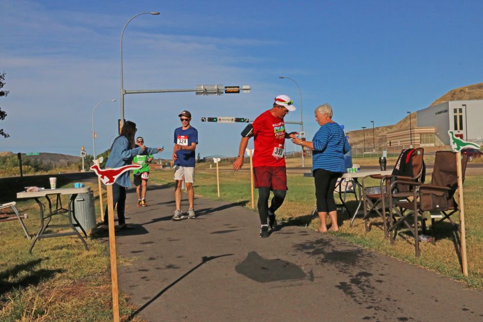  Kim Clozza, left, and Phyllis Laval offer refreshments to competitors at the Dinosaur Valley Dinosaur Half Marathon Sunday, September 10. mailphoto by Patrick Kolafa