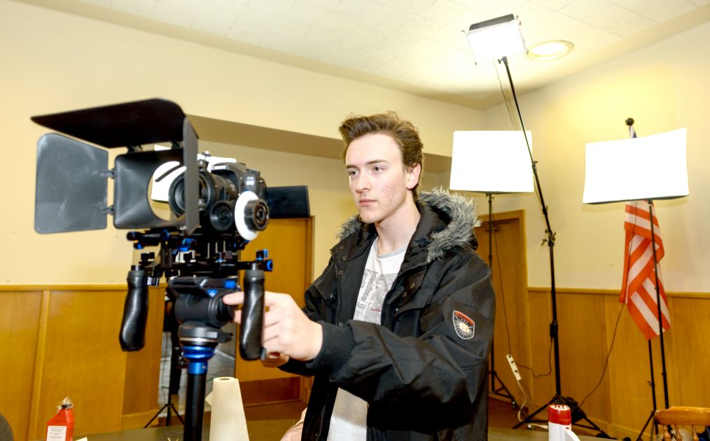 Director Brandon Watson, 17, checks the exposure and lighting of the room before the biggest scene of the movie is recorded on Saturday, March 17, at the old court house. mailphoto by Terri Huxley